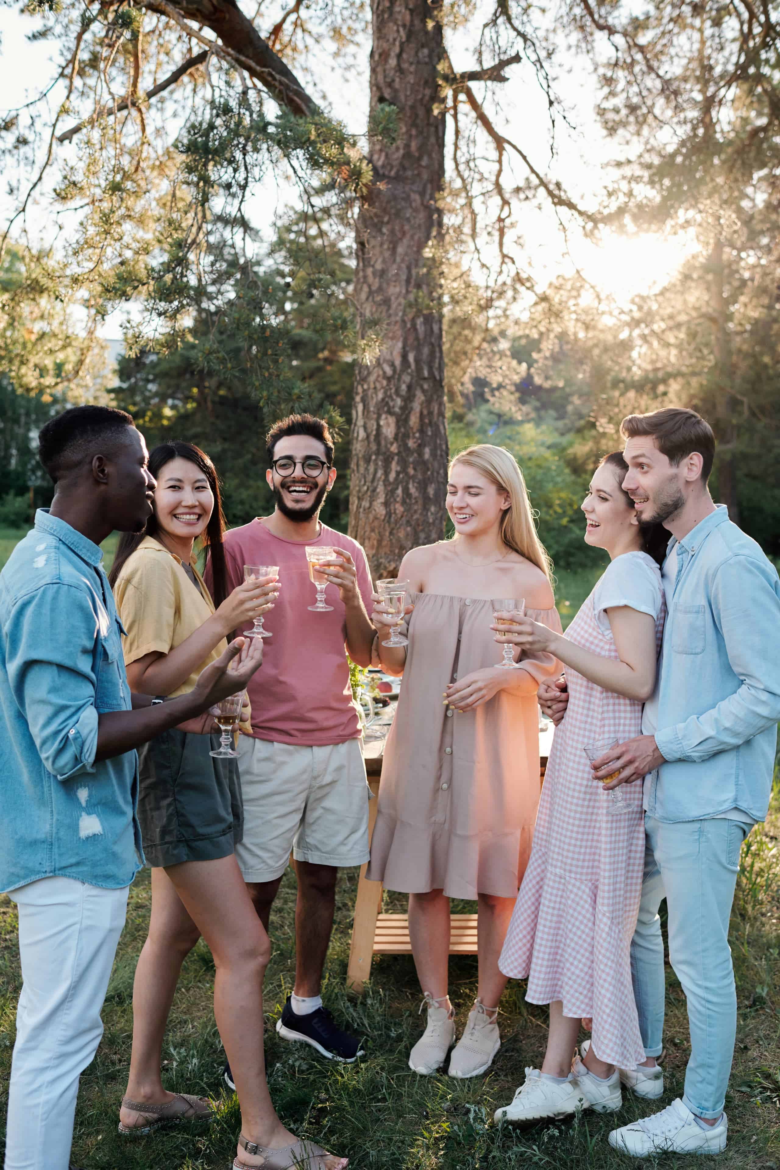 young-cheerful-men-and-women-of-various-ethnicities-cheering-up-with-drinks